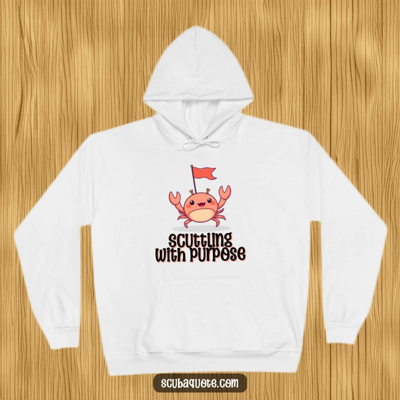 Funny hoodie featuring a happy crab scuttling forward with a tiny flag, designed for warmth and cheerful, determined vibes.
