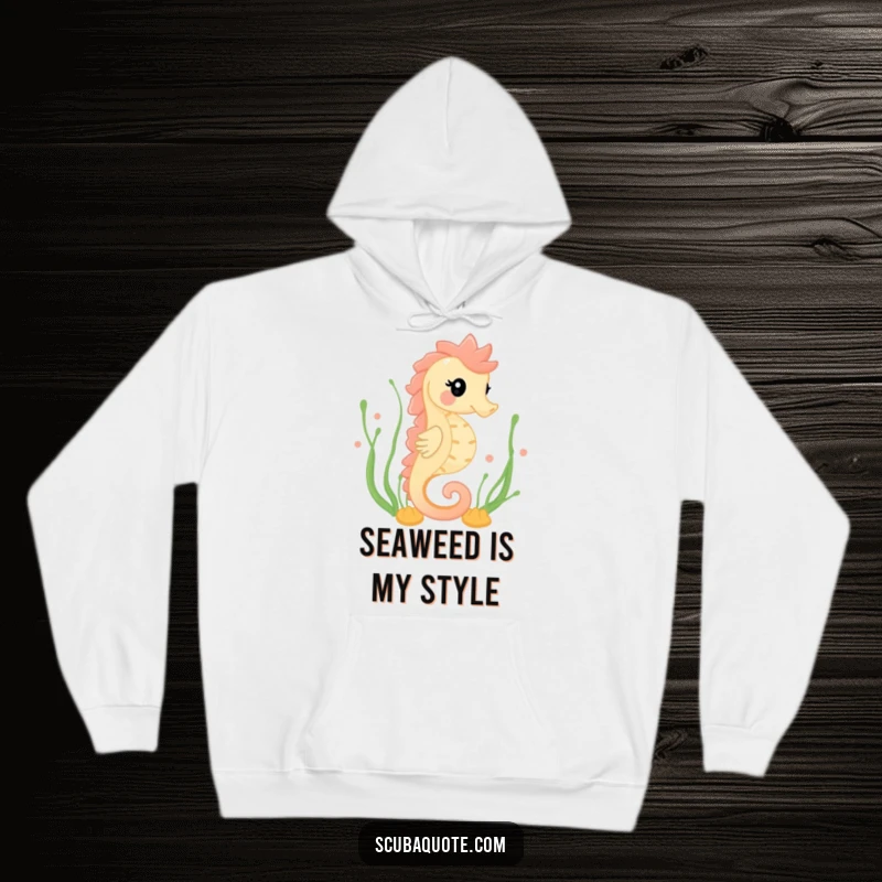 Funny hoodie featuring a happy seahorse gracefully swimming amidst seaweed, offering cozy comfort and serene ocean aesthetics.